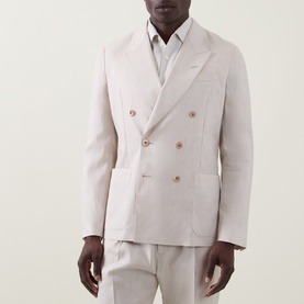 Model wearing Paul Smith white linen-wool double-breasted blazer with gold buttons, styled with matching trousers and white shirt.