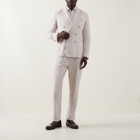 Model wearing Paul Smith white linen-wool double-breasted jacket, styled with matching trousers and dark brown loafers.
