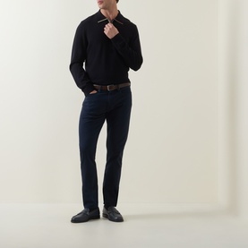 Model wearing Paul Smith Blue Merino Wool Polo, styled with dark navy trousers, brown leather belt and black loafers.