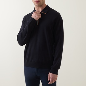Model wearing Paul Smith blue merino wool half-zip polo jumper, paired with navy trousers. Multicolour zip pull detail visible.