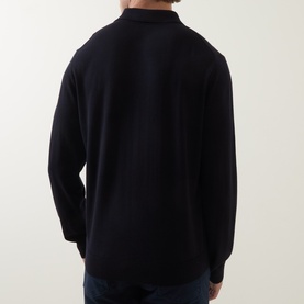Model wearing Paul Smith blue merino wool polo knit, rear view showing long sleeves and ribbed collar.