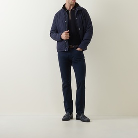 Model wearing Paul Smith Blue Merino Wool Polo, styled with navy quilted jacket, dark jeans, and black loafers.