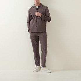 Model wearing Paul Smith grey button-up jacket with matching grey trousers and white trainers.