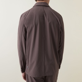 Model wearing Paul Smith grey jacket, rear view, relaxed fit with long sleeves and subtle collar, styled with matching grey trousers