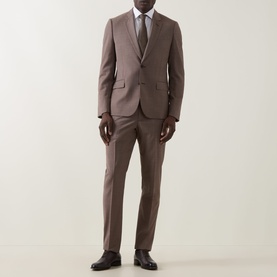 Model wearing Paul Smith Soho Single-Breasted Two-Piece Suit in brown, styled with white shirt and tie, dark Oxford shoes.