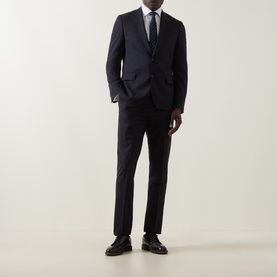 Model wearing Paul Smith Soho Pinstripe Single-Breasted Two-Piece Suit in navy wool, styled with a grey tie and black leather shoes.
