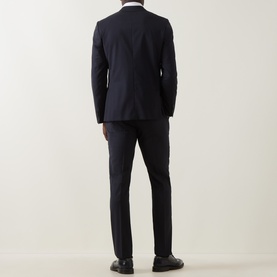 Model wearing Paul Smith Soho Pinstripe Single-Breasted Two-Piece Suit in navy wool, rear view, styled with black dress shoes.