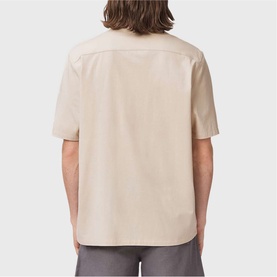 Model wearing All Saints birch white short-sleeve shirt, rear view, relaxed fit with camp collar silhouette.