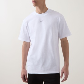 Model wearing Hugo white cotton crew neck T-shirt with small chest logo print, styled with black trousers