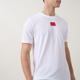 Model wearing Hugo white cotton T-shirt with small red logo patch on chest