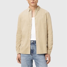 Model wearing All Saints cord brown corduroy shirt, styled with a white T-shirt and light blue jeans