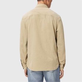 Model wearing All Saints cord brown long-sleeve overshirt, back view, styled with light blue jeans.