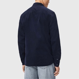 Model wearing All Saints sapphire blue corduroy shirt, back view, styled with light wash jeans