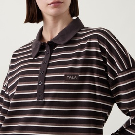 Model wearing Tala Striped Logo Rugby Top in Mocha Brown with polo collar, front button fastenings, and logo patch detail.