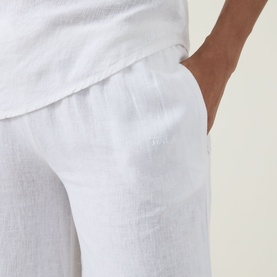Model wearing Tala Soft Wide Leg Trousers in ivory linen-viscose blend, showing elasticated waist and side pocket detail.
