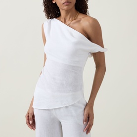 Model wearing Tala ivory one-shoulder linen-viscose top, styled with matching wide-leg trousers