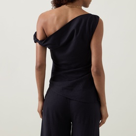 Model wearing Tala top in Shadow Black, one-shoulder asymmetric neckline, linen-viscose blend, styled with matching wide-leg trousers