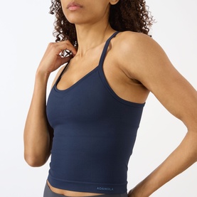 Model wearing Adanola navy blue seamless tank top with thin straps, paired with matching navy leggings