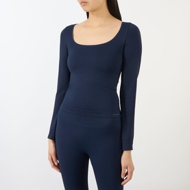 Model wearing Adanola navy blue long-sleeve scoop-neck top with ribbed waistband detail, styled with matching navy leggings.