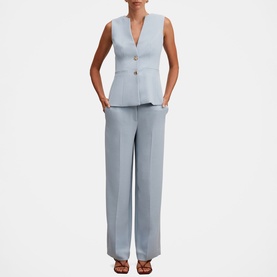 Model wearing Forever New Ice Blue sleeveless tailored vest and wide-leg trousers, styled with brown strappy heels.