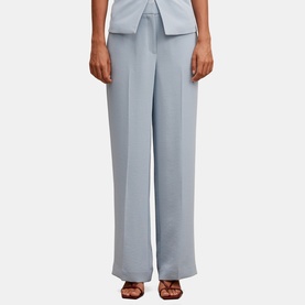 Model wearing Forever New Ice Blue wide-leg tailored trousers with centre front pleat, styled with matching top and brown strappy heels.