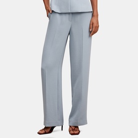 Model wearing Forever New ice blue wide-leg tailored trousers with front press crease, styled with matching top and brown strappy heels.