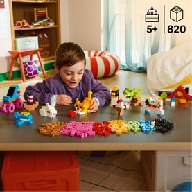 Child playing with Lego Classic Creative Colourful Bricks Set, 820-piece multicoloured build displayed on table, age 5+