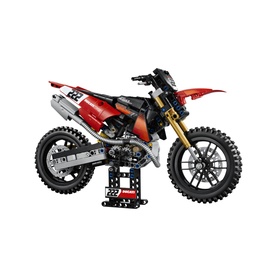 Lego Technic motocross dirt bike model in red, black and silver, displayed on stand, detailed with number 22 racing graphics