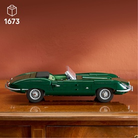 Lego Icons Jaguar E-Type buildable model set, dark green convertible sports car displayed on wooden surface, 1673 pieces