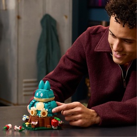 Model with Lego Pok&eacute;mon buildable figure set in teal and multi colours, shown assembled on a dark surface