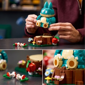Lego Pok&eacute;mon multi-coloured building set featuring a large Squirtle figure with smaller figures and floral details, shown being assembled