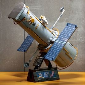 Lego Icons Hubble Space Telescope buildable model, multi-coloured brick build with solar panels, displayed on decorative stand