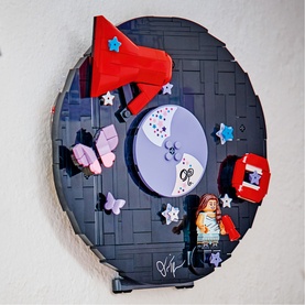 Lego Editions Music multi-coloured circular wall display with minifigure, red megaphone, vinyl record, butterflies, and star details