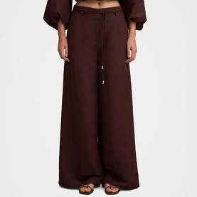 Model wearing Forever New chocolate wide-leg trousers with drawstring waist, styled with matching balloon-sleeve top and brown sandals.