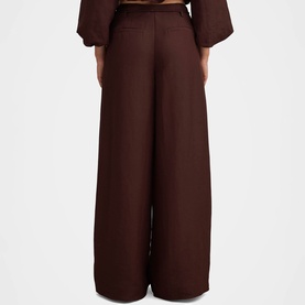 Model wearing Forever New chocolate wide-leg trousers, rear view, styled with matching chocolate top
