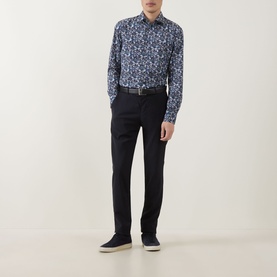 Model wearing Paul Smith Navy Single Cuff Slim formal shirt with floral print, styled with dark trousers and navy trainers.