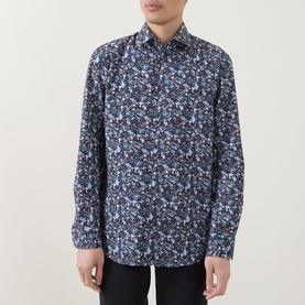 Model wearing Paul Smith navy floral print slim fit cotton formal shirt with single cuffs, styled with dark trousers.