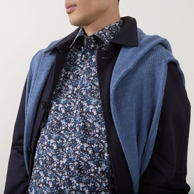 Model wearing Paul Smith Navy Single Cuff Slim formal shirt in floral print, styled with a blue textured gilet and dark navy coat.