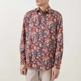 Model wearing Paul Smith red floral cotton slim fit single cuff shirt, styled with light grey trousers.