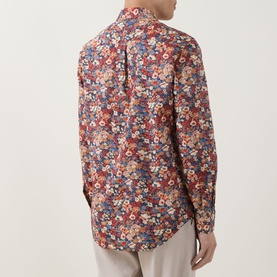 Model wearing Paul Smith red floral print slim fit cotton formal shirt, single cuff, styled with light grey trousers. Rear view.