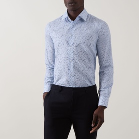 Model wearing Paul Smith Ditsy Floral Single-Cuff Shirt in blue with small floral print, styled with dark navy trousers.