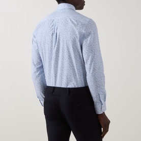 Model wearing Paul Smith Ditsy Floral Single-Cuff Shirt in blue, rear view showing all-over floral print, styled with navy trousers.