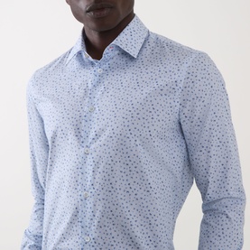 Model wearing Paul Smith Ditsy Floral Single-Cuff Shirt in blue, featuring all-over ditsy floral print, pointed collar, and slim fit.