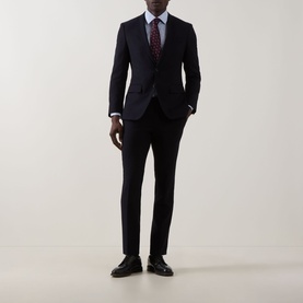Model wearing Paul Smith Ditsy Floral Single-Cuff Shirt in blue, styled with a navy suit, burgundy floral tie, and black leather shoes.