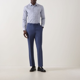 Model wearing Paul Smith White Single Cuff Slim formal shirt with blue print, styled with navy tailored trousers and black leather shoes.