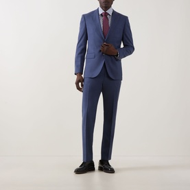 Model wearing Paul Smith white slim single cuff shirt styled with blue suit, burgundy tie and black loafers.