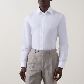 Model wearing Paul Smith Solid Single-Cuff Shirt in white cotton, classic collar, long sleeves, styled with grey tailored trousers.