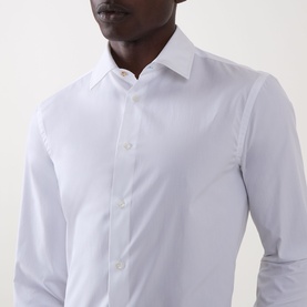Model wearing Paul Smith Solid Single-Cuff Shirt in white. Classic collar, button fastening, slim fit, long sleeves. 100% cotton.