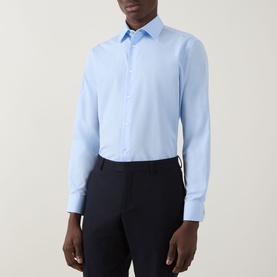 Model wearing Paul Smith Solid Single-Cuff Shirt in blue, classic collar, long sleeves, styled with navy trousers.