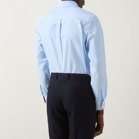 Model wearing Paul Smith Solid Single-Cuff Shirt in blue, rear view, styled with navy trousers. Classic collar, long sleeves, single cuff.